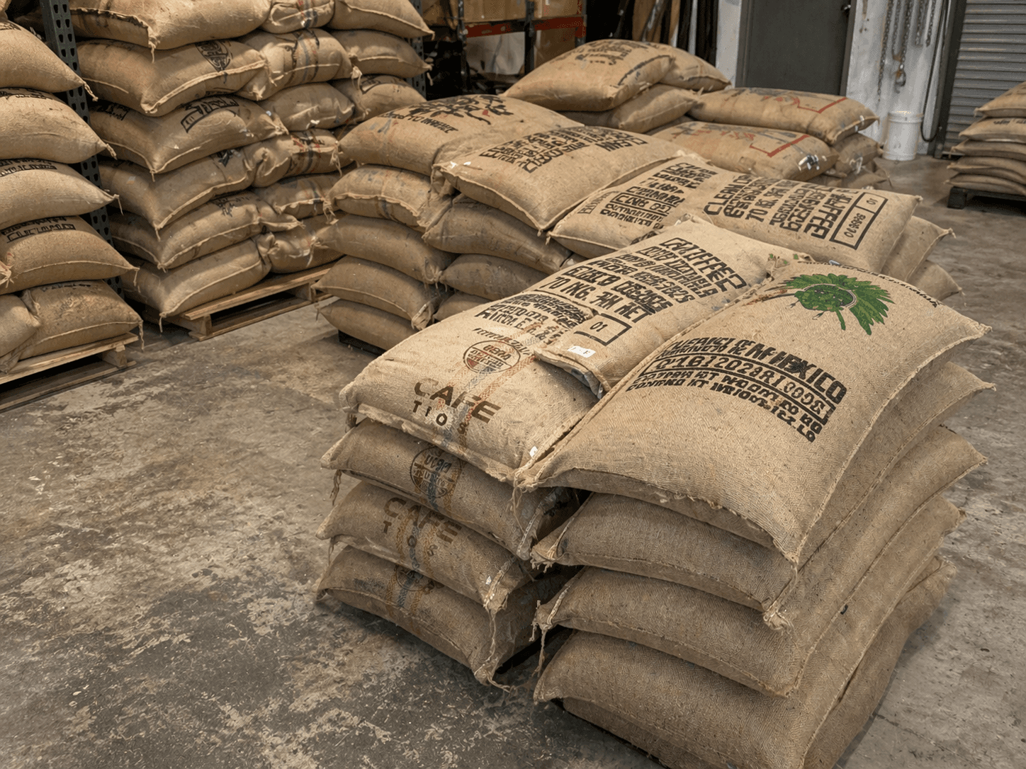 Green coffee sacks stacked in the Spur roastery